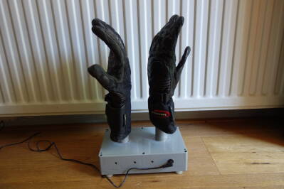 Wet motorcycle gloves, drying on the glove dryer